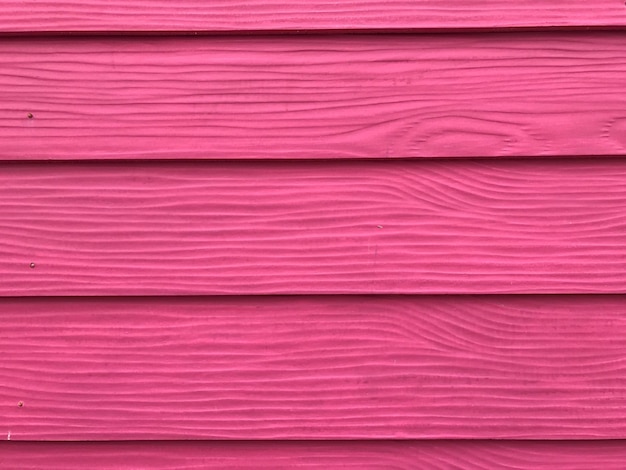 Fotografía completa de la pared de madera rosada