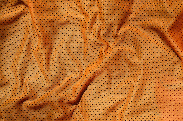 Foto fotografía completa de textil naranja arrugado