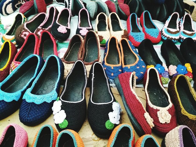 Foto fotografía completa de zapatos de varios colores en el puesto del mercado