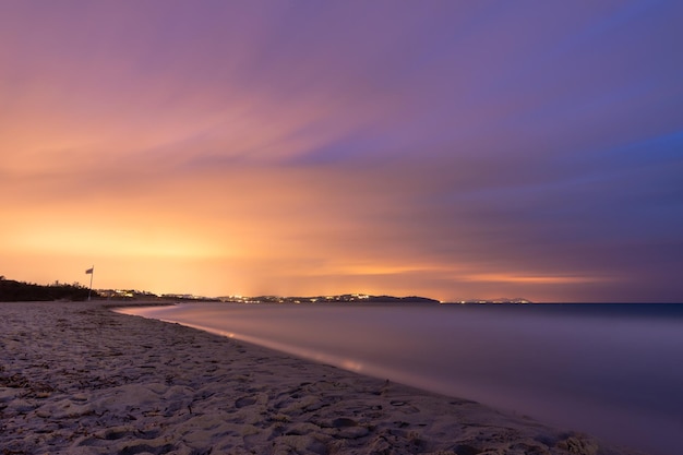 Fotografia de longa exposição na praia ao pôr do sol