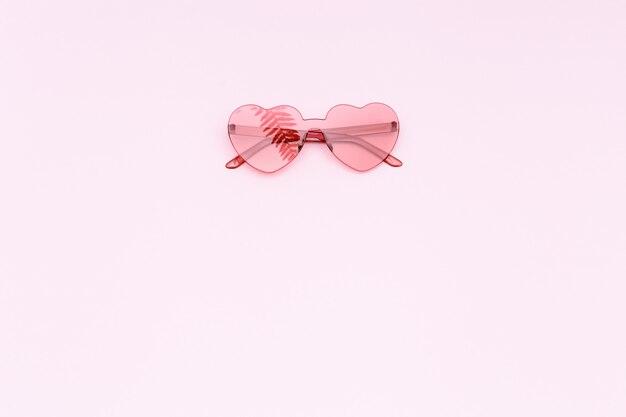Fotografia de moda estilo minimalista com óculos vermelhos em forma de coração