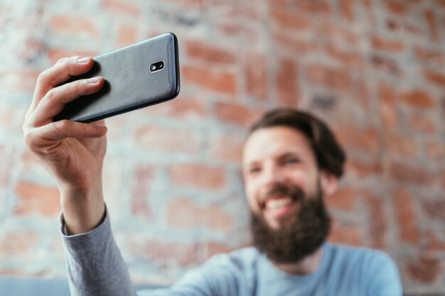 Fotografía móvil. tecnología y dispositivos digitales. hombre tomando selfie con teléfono.