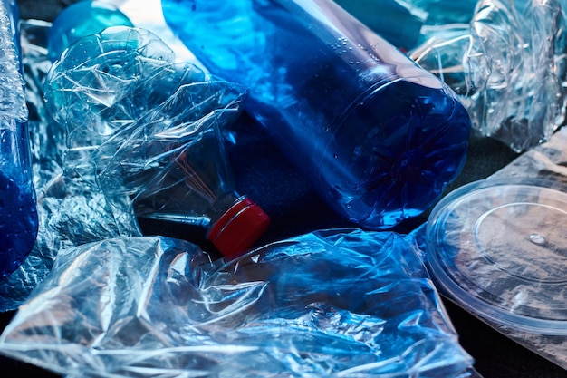 Fotografía de Stock de un montón de residuos plásticos que simboliza el concepto de contaminación y el medio ambiente sobre un fondo negro