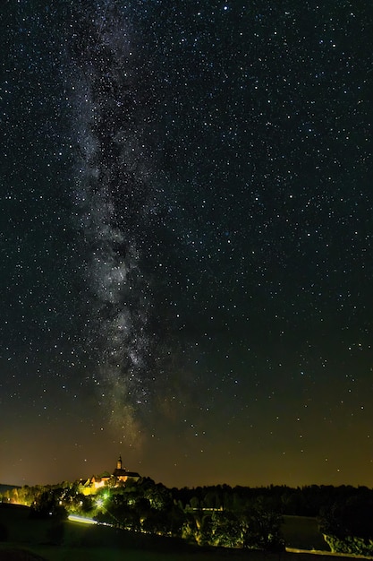 Fotografía vertical de un hermoso cielo de la Vía Láctea sobre la abadía de Andechs, Baviera, Alemania