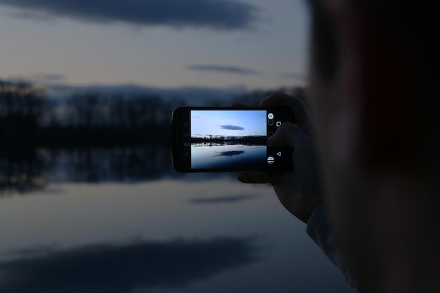 Foto fotografieren der menschlichen hand mit einem smartphone