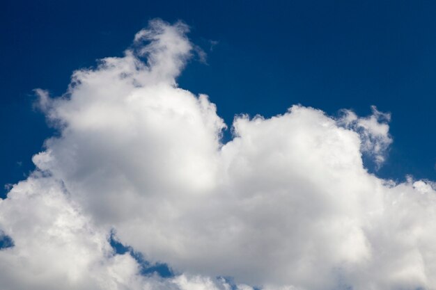 Fotografierte weiße Wolken aus der Nähe sind am blauen Himmel, geringe Schärfentiefe