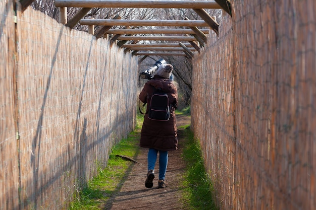 El fotógrafo de aves caminando por un sendero y de regreso a casa.