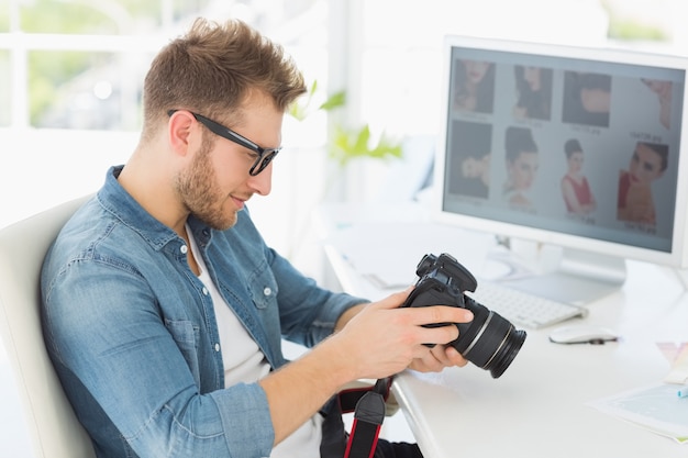 Fotógrafo bonito olhando para sua câmera