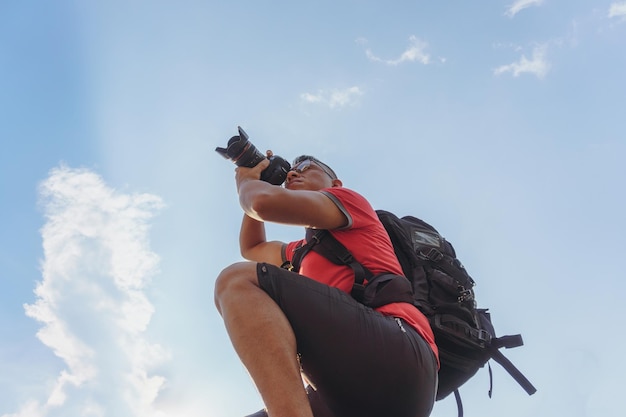 Fotógrafo con cámara tomando fotos del atardecer