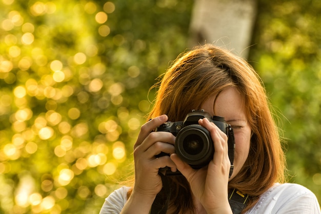 Fotógrafo de garota tira fotos na natureza