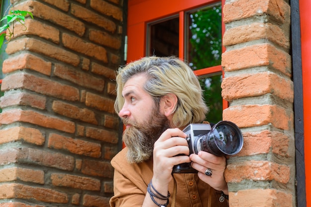 Fotógrafo paparazzi fotoperiodista fotógrafo masculino tomando fotografía hombre barbudo con