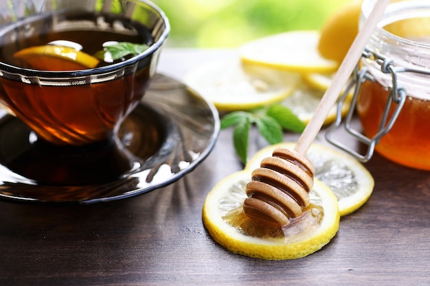 Una fragante miel fresca con una taza de té negro.