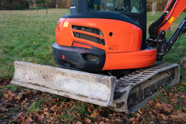 Fragment eines orangefarbenen Baggers und Raupenbulldozers