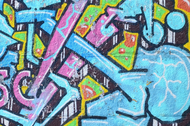 Foto fragmento de desenhos de graffiti a velha parede decorada com manchas de pintura no estilo da cultura da arte de rua textura de fundo colorida em tons frios