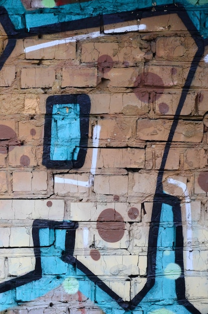 Fragmento de dibujos de graffiti El antiguo muro decorado con manchas de pintura al estilo de la cultura del arte callejero Textura de fondo coloreada