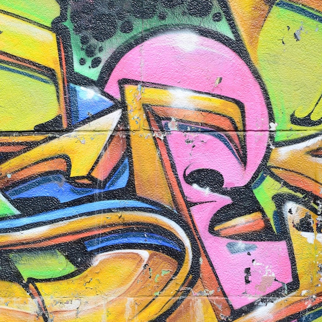 Fragmento de dibujos de graffiti El antiguo muro decorado con manchas de pintura al estilo de la cultura del arte callejero Textura de fondo multicolor