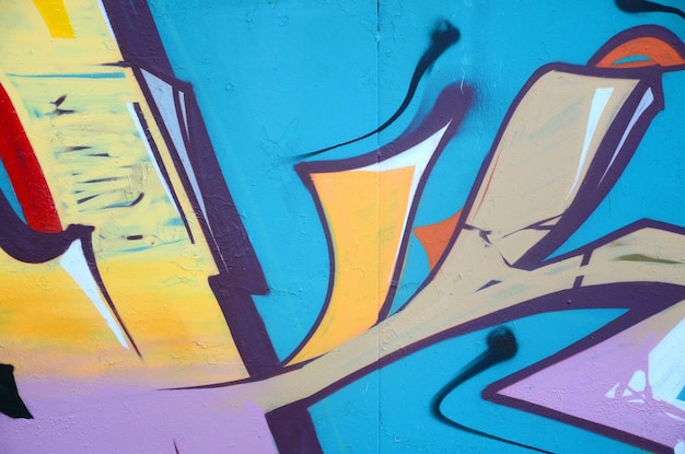 Fragmento de dibujos de graffiti La vieja pared decorada con manchas de pintura en el estilo de la cultura del arte callejero Textura de fondo de color