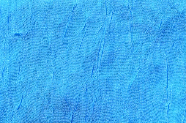 Fragmento de material de tela azul arrugada como textura de fondo