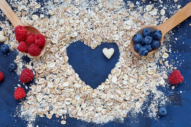 Frambuesas y arándanos sobre fondo azul. Cereales.