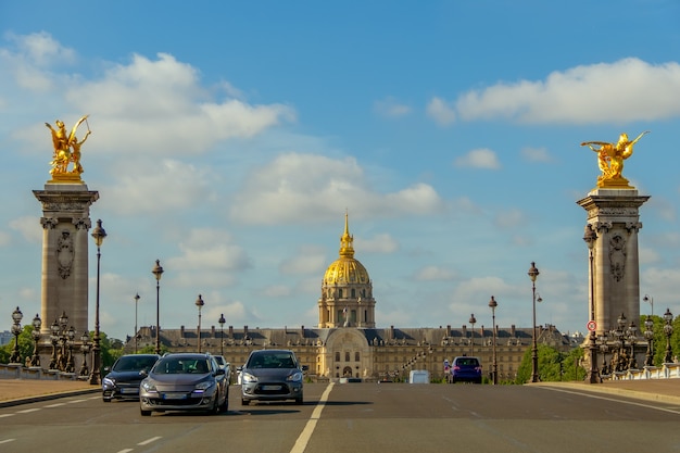 Frankreich. Sonniger Sommertag in Paris. Autos auf der Brücke von Alexander III und Fassade der Esplanade Invalides