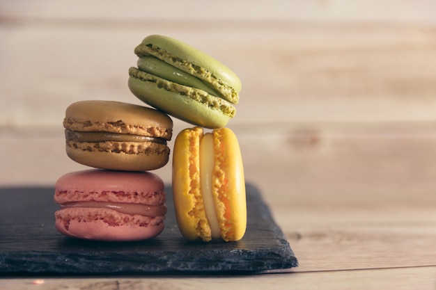 Französische Macarons Cookies in Pastellfarben auf Schiefertablett Textfreiraum Selektiver Fokus