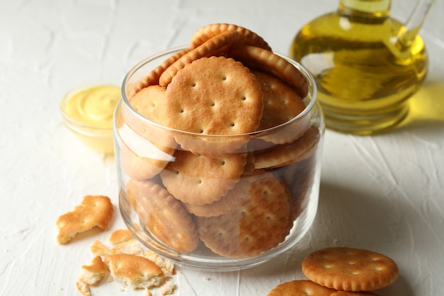 Frasco de vidrio con galletas saladas, salsa y aceite.