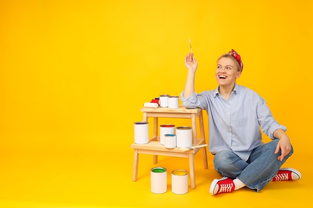 Frascos com tintas e garota no espaço de fundo amarelo para texto