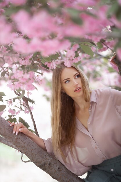 Frau am blühenden Sakura-Baum auf Natur