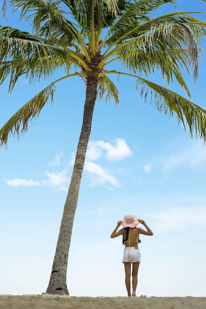 Frau am Strand mit Palme