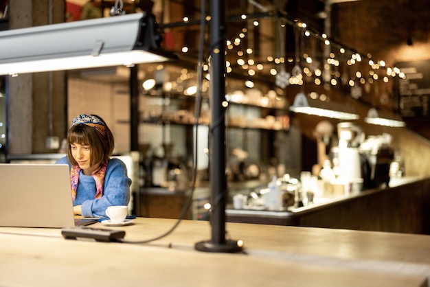 Frau arbeitet am Laptop im Café