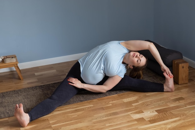 Frau beim Yoga Weitwinkelsitzende Vorwärtsbeuge, Upavishtha Konasana