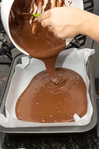 Frau bereitet Brownie zu Hause selbst gemachten Schokoladen-Brownie zu