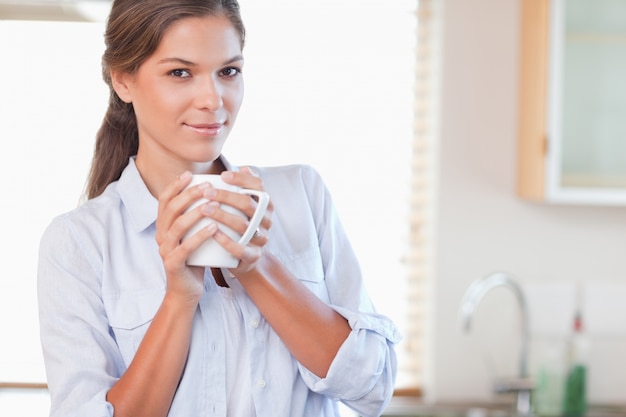 Frau, die eine Tasse Tee anhält