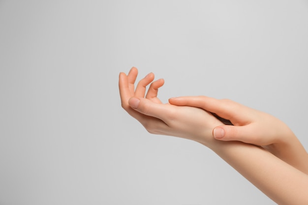 Frau, die Handcreme für Hände anwendet.