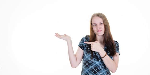 Frau, die Handfläche zeigt, die mit dem Finger zeigt und Kamera auf weißem Hintergrund beiseite kopiert