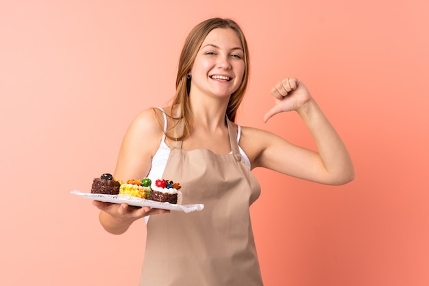 Frau, die Kuchen im Studio hält