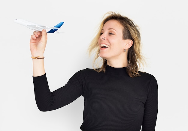 Foto frau, die mit flugzeugspielzeug spielt