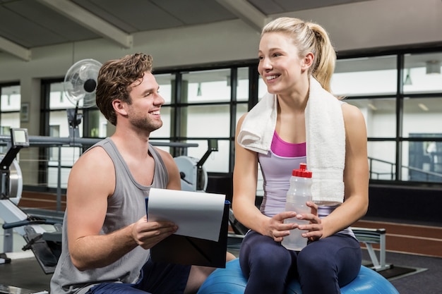 Frau, die mit ihrem Trainer nach einem Training spricht