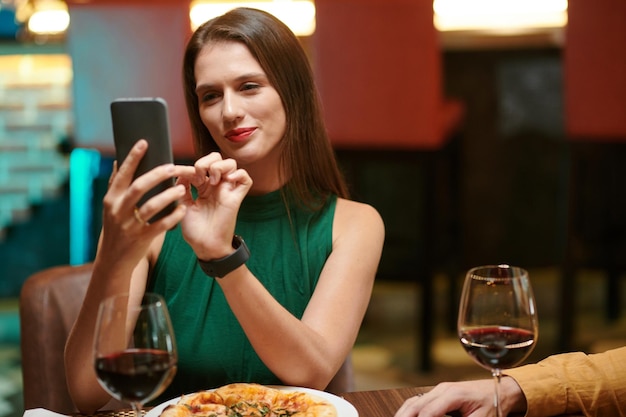 Frau, die Selfie in schickem Restaurant macht