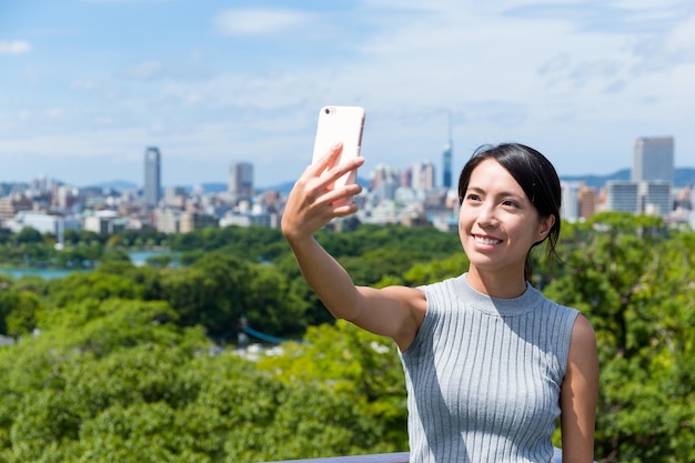 Frau, die selfie per handy in der stadt fukuoka macht