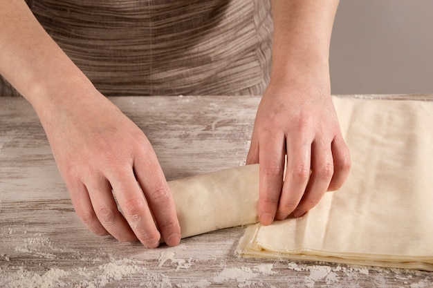 Frau, die Thunfischrollen mit Phyllo-Teig zum Backen macht