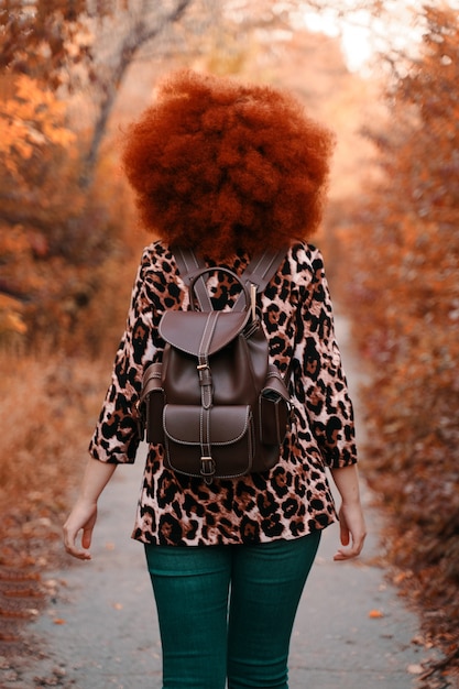 Frau geht im Herbst in den Park