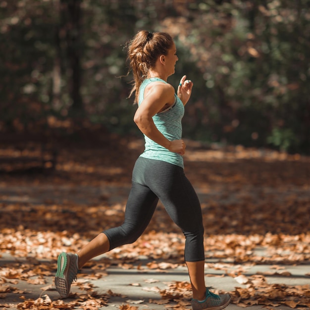 Frau im Herbst im Freien joggen