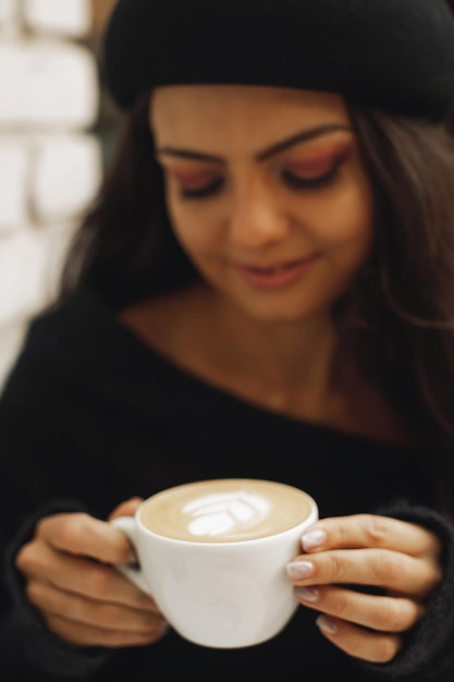 Frau im Hut mit Tasse Kaffee