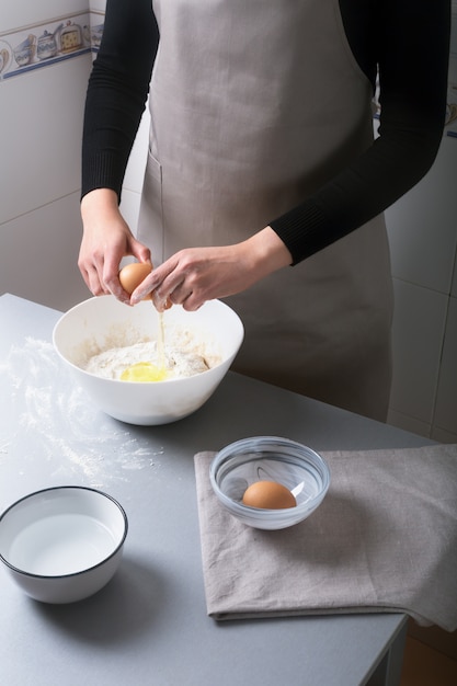 Frau in der Küche zu Hause bereitet den Teig mit Mehl zu, um Bio-Pfanne, Brot oder Nudeln zu machen