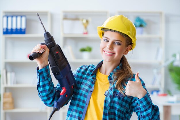 Foto frau in der werkstatt mit bohrmaschine