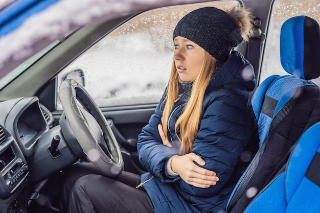 Frau in einem Auto bei Schneefallproblemen auf der Straße