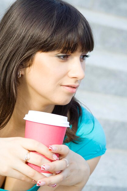 Frau in einem Park Kaffee trinken