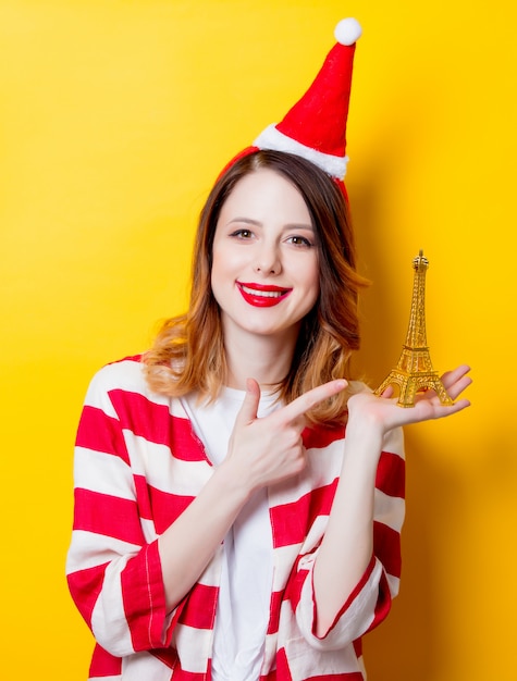 Frau in Nikolausmütze mit Eiffelturm Geschenk