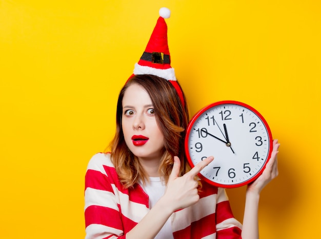 Frau in Santa Claus-Hut mit Uhr